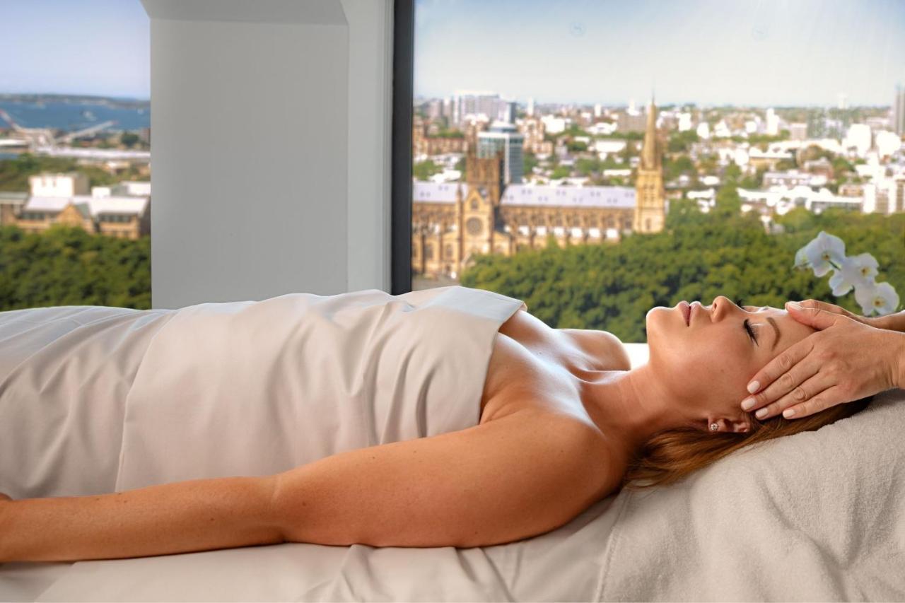 Sheraton Grand Sydney Hyde Park Exterior photo A woman receiving a head massage